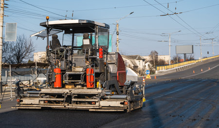 Modern asphalt paver machine working on city streetの写真素材