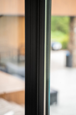 Wide architectural frame shot of black aluminum windows with layered glazingの写真素材