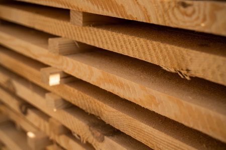 Closeup of stacked pine wood planks with natural rough sawn textureの写真素材