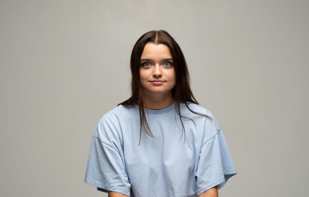 Young woman with serious face looking at camera