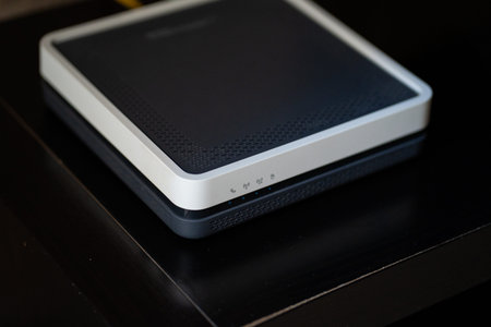 Wireless internet router providing network connectivity and broadband access, with indicator lights blinking, symbolizing global communication and digital technology at homeの写真素材