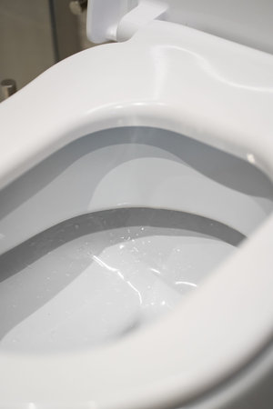 White clean toilet with open seat, modern bathroom fixture illustrating hygiene, sanitation, and essential plumbing for a fresh, healthy domestic environmentの写真素材