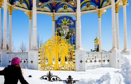 Flying to god. Girl is flying to summer altar in the Pochaev lavra throuth very big snowdrift.のeditorial素材