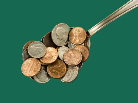 Iron kitchen spoon with coins, closeup. Go out and slap up dinner.   の写真素材