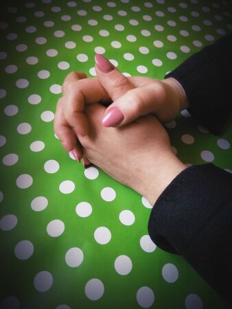 girl's hands on a green backgroundの写真素材