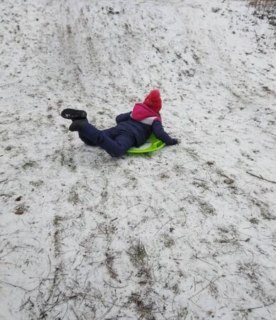 girl rides on the ice from the mountainの写真素材