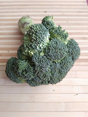 Broccoli on a wooden merchabの写真素材