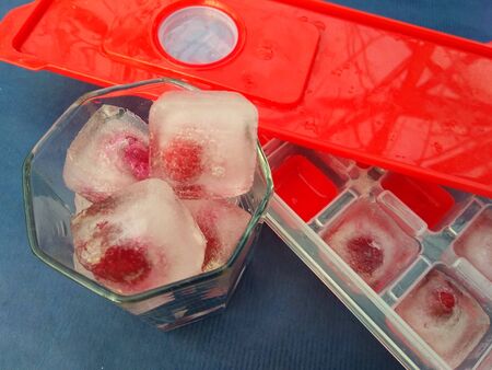 ice with cherry shaped on a blue backgroundの写真素材
