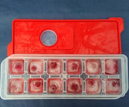ice with cherry shaped on a blue backgroundの写真素材