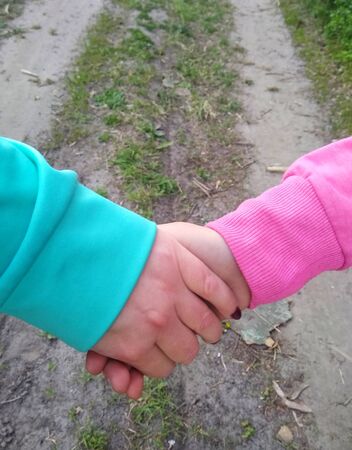 woman with girl hold handsの写真素材