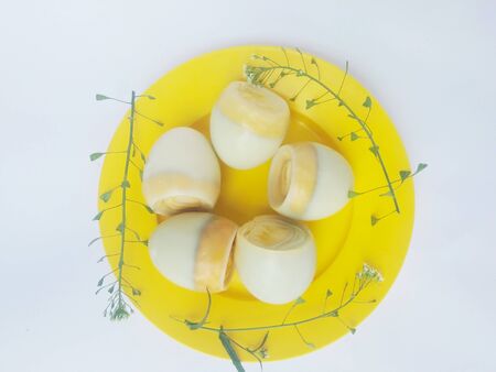 eggs in a plate with grass on a white backgroundの写真素材