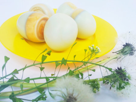 boiled eggs in a plate on a white backgroundの写真素材