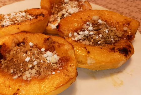 Baked quince in caramel sauce with nutsの写真素材