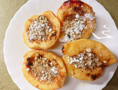 Baked quince in caramel sauce with nutsの写真素材