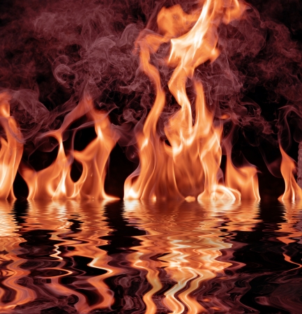 Fire flames and reflection in waterの写真素材