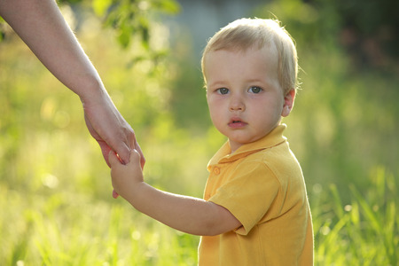 Mother and son holding hand in handの写真素材