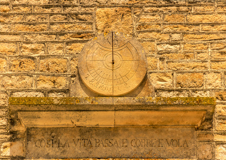 ARCHITECTURE AND BUILDINGS.Sundial: "Thus life passes and runs and flies." ITALYの写真素材