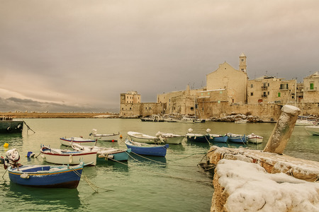SEASCAPE WINTER.Giovinazzo's harbour.ITALY (Apulia) .View of snow covered old town: on the background Cathedral of Santa Maria Assunta in Apulian Romanesque style.のeditorial素材
