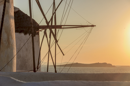 Seascape at sunset with white famous windmills, the symbol of Mykonos Cyclades, Greece.の写真素材