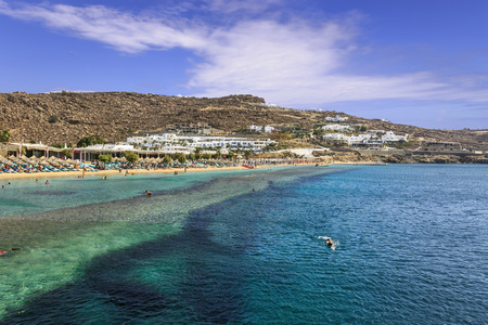 Summertime. Mykonos: Paradise beach (Kalamopodi),Greece. Sunny with blue sky and crystal clear water. Paradise is definitely the most famous beach of Mykonos: thin sand and emerald green water.のeditorial素材