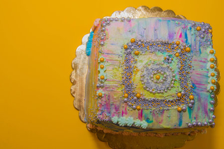 colored cake on a yellow backgroundの写真素材