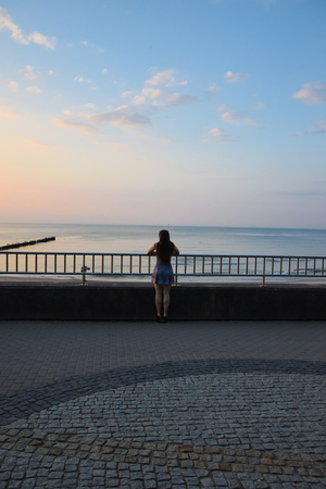 the girl looks at the seaの写真素材