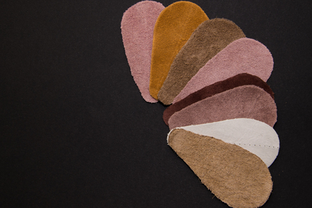 Pieces of leather of different types and colors, in the studio of shoesの写真素材