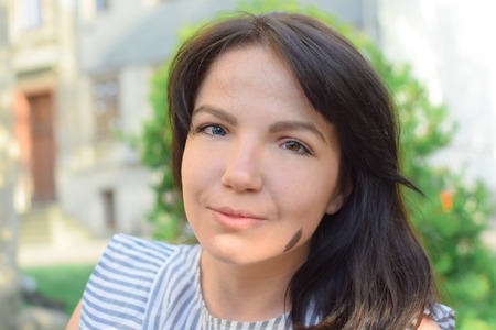 Beautiful brunette with different eye color heterochromiaの写真素材