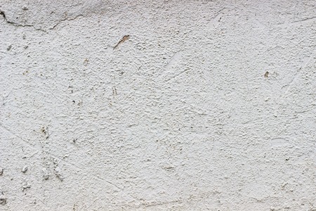 The old weathered white cement wall for designの写真素材