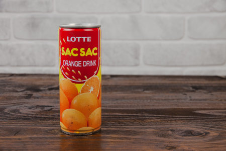 A vintage aluminum can of Lotte soft drink against the brick wal