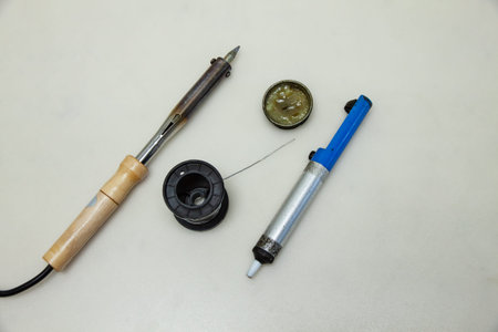Soldering iron with soldering accessories on a white background. Electronics service center