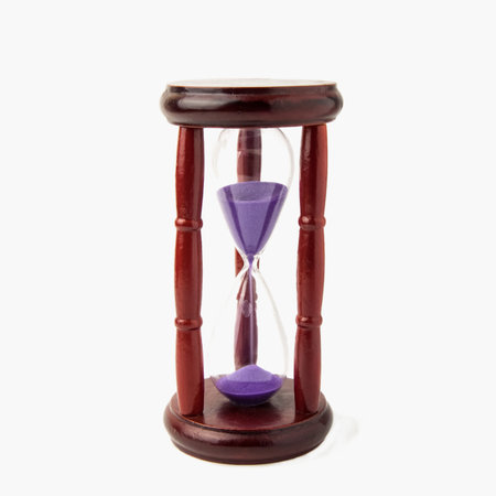 Wooden vintage hourglass isolated on white background. Close up