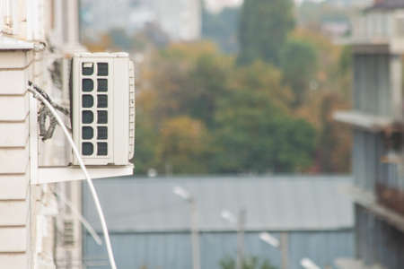 Compressor installation of air conditioning on the wall of a multi-storey building. Side viewの写真素材