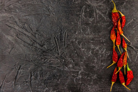 Hot red pepper dry lies on a black background. The view from the top and blank space for textの写真素材