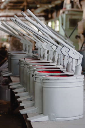 Gray-red pumps hand pumps for pumping liquid close-up in the finished product warehouse. Industrial productionの写真素材