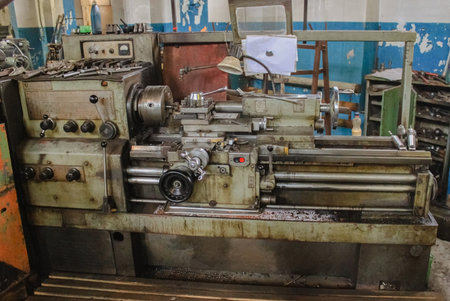 An old lathe in oil and metal shavings. Turner's workplace