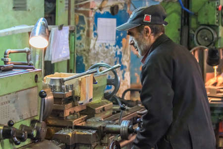 Krasnodar, Russia - October 10, 2011: A man in the shop works on a latheのeditorial素材