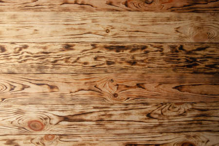 Pine boards with knots after firing and brushing. Wood texture close-up. Background imageの写真素材