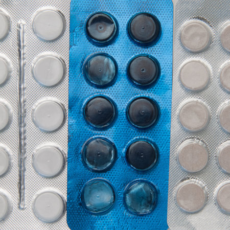 Silver and blue blister packs with tablets Background image. Close-up