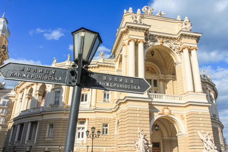 Odessa, Ukraine, October 9, 2012: An old signpost of Lanzheronovskaya Street against the background of the Odessa Opera and Ballet Theater. A landmark of Eastern Europeのeditorial素材