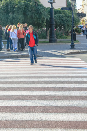 Odessa, Ukraine, October 9, 2012: A man alone crosses the street at a pedestrian crossing. The old part of the city of Odessaのeditorial素材