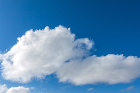 Blue sky with white fluffy clouds. Background image of the sky and clouds