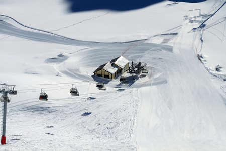 Top view of the ski slope, the chairlift and the two lodges. Winter landscape of the ski resort. Winter sports during the vacationsの写真素材