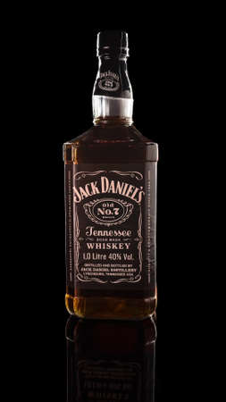 Jack Daniels Old No.7 on a black background with a beautiful reflection. Bottle of American whiskey known throughout the world. Russia, Krasnodar, December 15, 2021のeditorial素材