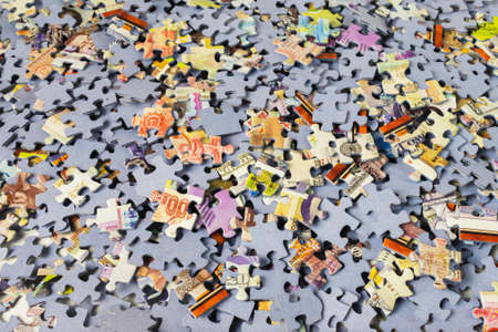 Background of colorful puzzle pieces. A bunch of jigsaw puzzle piecesの写真素材