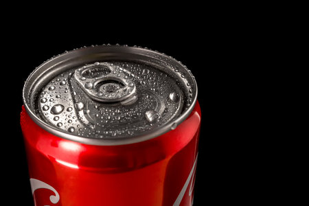 Side view of a red aluminum can with water drops on a black background. close-upの写真素材