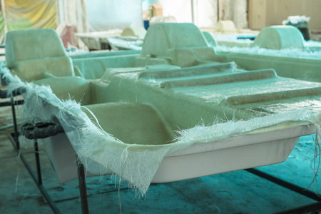 Bottom part of the hull of a pedal catamaran glued with fiberglass. Construction of boats in a...