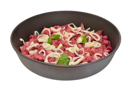 Raw beef in a frying panの写真素材