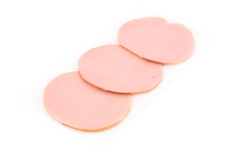 Three slices of wurst in a plastic white container isolated on white background