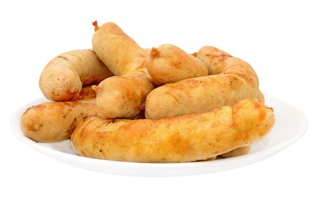 Grilled chicken sausages on a plate isolated on white backgroundの写真素材